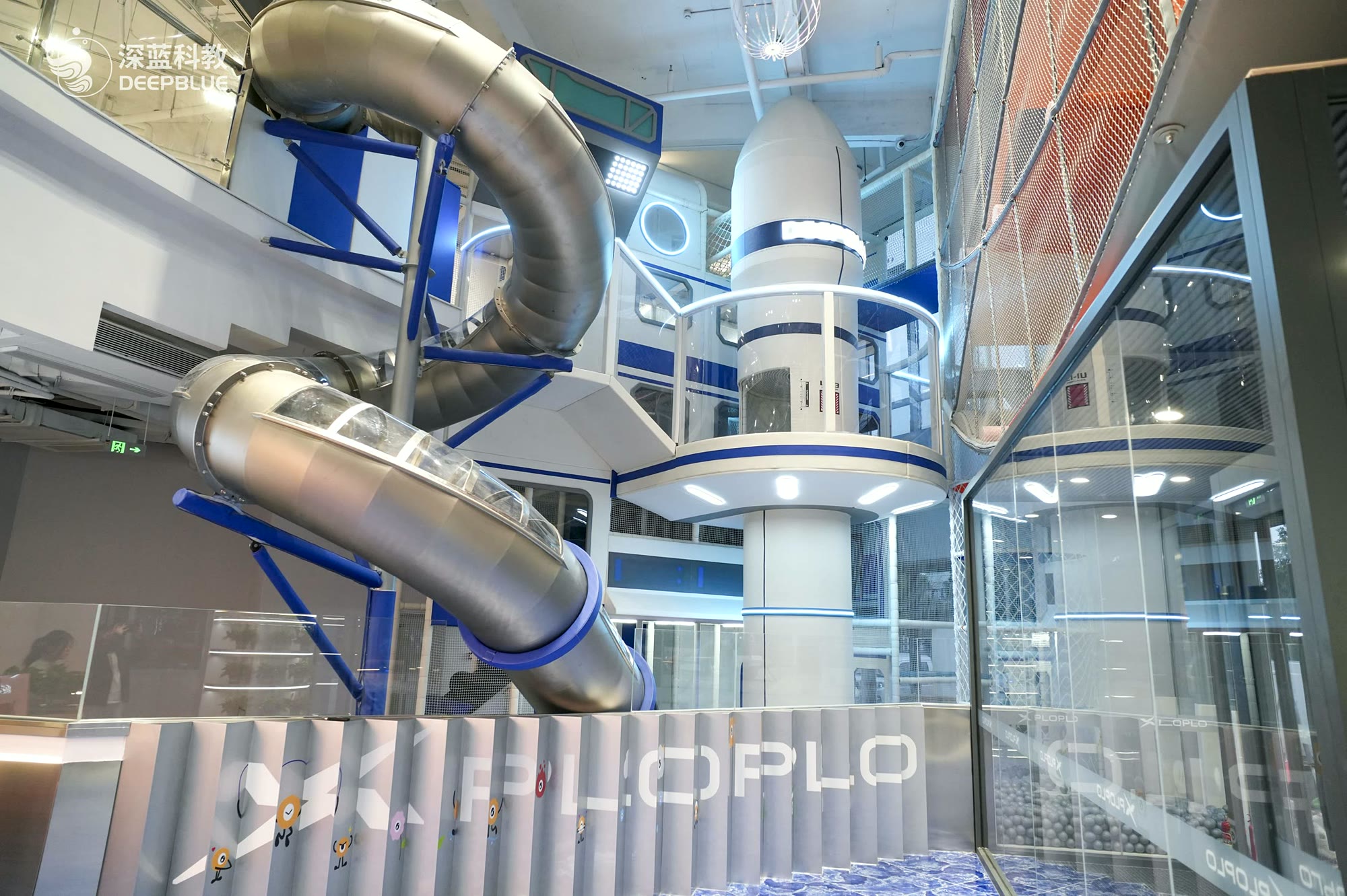 Children exploring hands-on science equipment inside DEEPBLUE's XPLOPLO museum