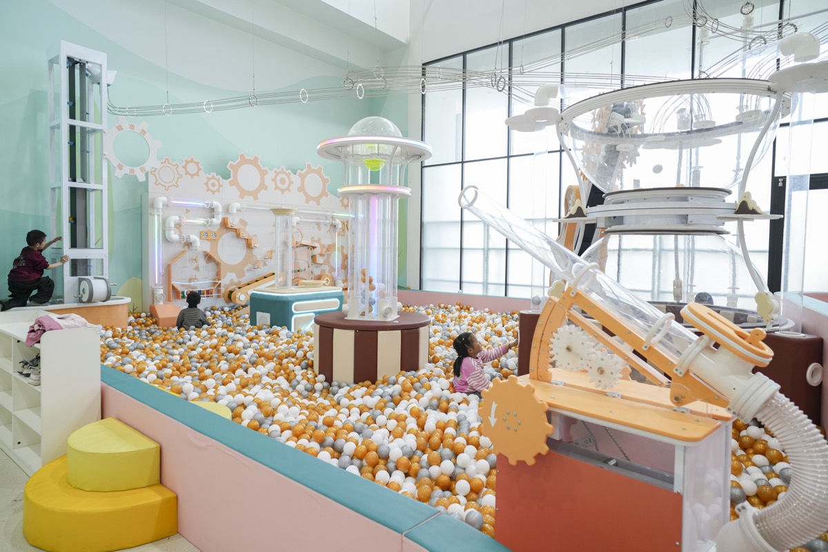 Children using a large air power ball exhibit in an exploration venue