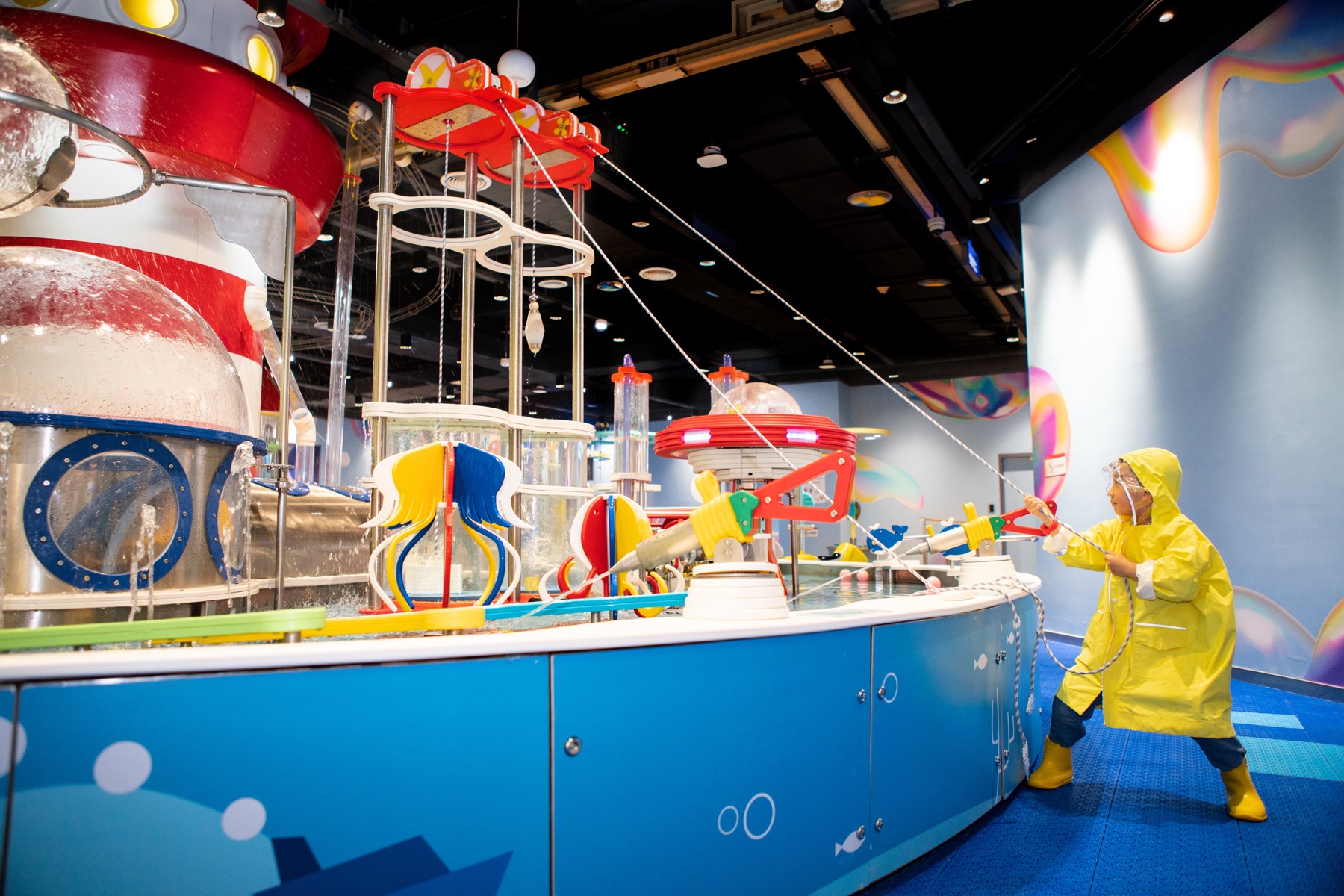 Child interacting with a water science exhibit in a completed DEEPBLUE venue Child interacting with a water science exhibit in a completed DEEPBLUE venue